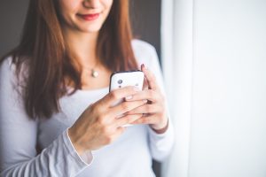 Woman with smartphone texting