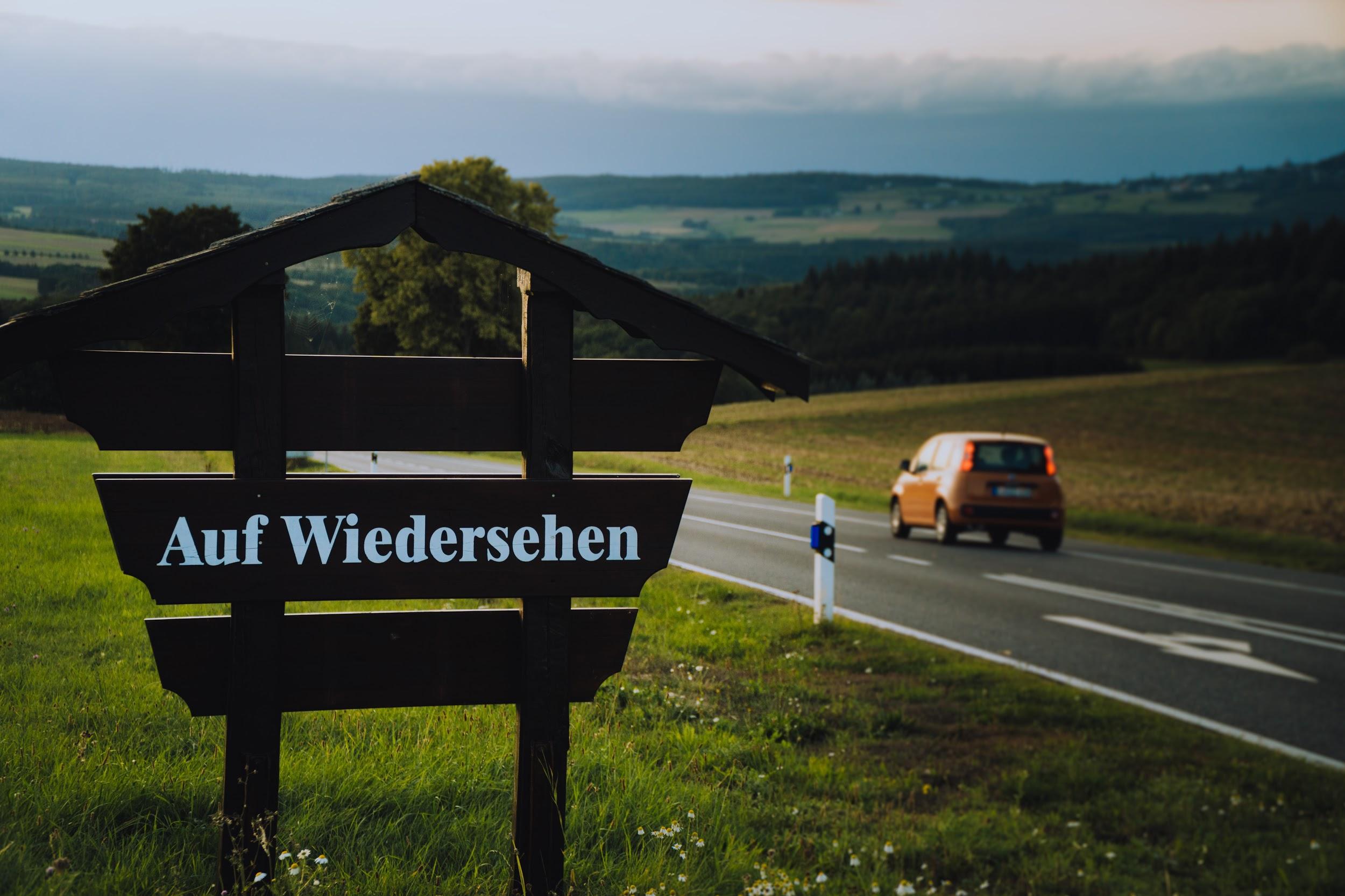 "Auf wiedersehen" ("Goodbye" in German) on a roadside sign